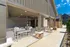 Elegant outdoor patio area with stylish seating and dining space, ideal for entertaining in a contemporary apartment complex.