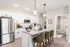 Modern kitchen with sleek stainless steel appliances, elegant granite countertops, and inviting bar seating, adjacent to a cozy bathroom.