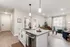 Modern open-plan apartment with sleek kitchen island, cozy living room, and inviting natural light through large windows.