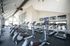 Modern gym facility equipped with high-quality Life Fitness treadmills and elliptical machines, featuring a spacious layout and vibrant lighting.