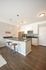 Modern kitchen with sleek stainless steel appliances, elegant granite countertops, and stylish pendant lighting, perfect for culinary adventures.