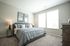 Bright and elegant bedroom with a comfortable king-size bed, stylish decor, and large windows providing ample natural light.