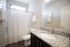 Elegant bathroom featuring a sleek granite countertop, modern fixtures, and a stylish shower curtain for a chic touch.