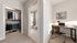 Chic apartment with a well-organized closet, modern bathroom, and a stylish workspace filled with natural light.