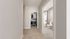 Luxurious apartment hallway with a spacious walk-in closet and modern bathroom featuring sleek fixtures.