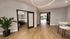 Sleek modern living space featuring elegant wood flooring, stylish sliding doors, and a cozy seating area with contemporary lighting.