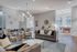 Elegant open-plan living room featuring modern furniture, stylish chandelier, and pool table with large arched windows for natural light.