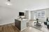 Modern open-concept living area with sleek kitchen island, chic decor, large windows, and natural light.