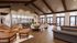 Expansive open-concept living space featuring high vaulted ceilings, elegant dining area, and a modern kitchen with stylish seating.