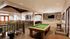Elegant living room with a stylish billiards table, cozy seating area, and open dining space, perfect for entertaining.