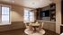 Charming dining area featuring a round wooden table surrounded by modern chairs, complemented by a stylish bookshelf and large windows with scenic views.