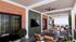 Chic and spacious outdoor terrace with elegant seating areas, modern ceiling fans, and lush greenery, perfect for entertaining or relaxing.