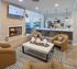 Inviting living space with modern fireplace, cozy seating, and stylish open kitchen, perfect for relaxation and entertaining.