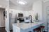 Modern kitchen with sleek stainless steel appliances, elegant granite countertops, and contemporary lighting.