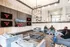 Inviting modern lounge area with cozy seating, a large TV displaying a sports scene, and stylish lighting; ideal for gatherings and relaxation.