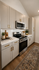 Elegant kitchen with modern appliances, sleek cabinetry, and stylish decor, featuring a cozy ambiance and sophisticated design.