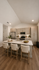 Modern kitchen with sleek countertops, stainless steel appliances, and elegant lighting, highlighting a cozy breakfast bar with stylish seating.