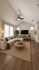 Elegant living room with vaulted ceilings, large windows, cozy seating, and modern decor.