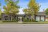 Inviting apartment complex entrance with modern design, lush greenery, and clear 'Now Leasing' signage, creating a welcoming atmosphere.
