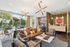 Chic lobby lounge with modern lighting, stylish furniture, and floor-to-ceiling windows overlooking a lush outdoor space.