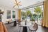 Chic interior with stylish lighting, modern seating, and vibrant poolside view, perfect for relaxation and entertaining.