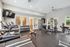 Bright and contemporary fitness center featuring state-of-the-art treadmills, weight rack, and versatile exercise machines.