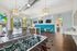 Modern recreation room featuring foosball and ping pong tables, stylish pendant lighting, and a vibrant seating area.