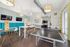 Chic and modern recreation room featuring a ping pong table, stylish seating areas, and a vibrant play setup.