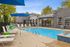 Chic and inviting outdoor pool area with sleek lounge chairs, vibrant umbrellas, and a stylish poolside setup perfect for relaxation and entertaining.