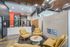 Modern apartment lobby featuring stylish yellow seating, sleek fireplace, and contemporary decor.