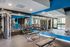 Modern fitness center with state-of-the-art gym equipment and mirrored walls, offering a bright and spacious workout environment.