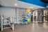 Inviting fitness center featuring modern exercise equipment, vibrant yoga balls, and a sleek, contemporary design.