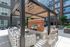 Modern outdoor patio featuring a stylish pergola, cozy seating, and a sleek brick fireplace, perfect for entertaining.