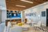 Contemporary community lounge with a sleek modern bar, stylish seating, and vibrant wall art, offering a welcoming atmosphere for relaxation and socializing.