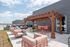 Chic rooftop terrace with stylish pergola, modern seating, and vibrant outdoor dining area perfect for leisure and entertainment.