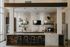 Modern apartment kitchen with sleek design featuring a chic coffee bar, stylish pendant lights, and inviting counter seating.