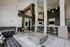 Modern apartment lounge featuring high ceilings, stylish furniture, and ambient lighting for an inviting atmosphere.
