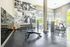 Bright and modern gym featuring state-of-the-art fitness equipment, sleek design, and inspiring wall art.