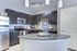 Modern kitchen with sleek dark cabinetry, stainless steel appliances, and a stylish granite island.