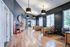 Inviting office space with high ceilings, modern lighting, and autumn-themed decor, creating a warm, professional atmosphere.