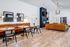 Modern lounge area with chic leather seating, vibrant artwork, and cozy fireplace, perfect for relaxation and socializing.