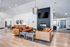 Chic and inviting living room with modern leather sofas, elegant fireplace, and abundant natural light, offering a perfect blend of comfort and style.