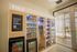 Modern apartment amenity featuring a Tulu rental station with snacks, beverages, and handy household items, all under bright natural lighting.