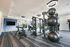 Modern gym with state-of-the-art equipment, sleek design, and panoramic mirrors for a premium workout experience.