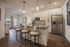 Modern kitchen with sleek cabinetry, stainless steel appliances, and stylish pendant lighting over a spacious island with seating.