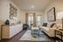 Inviting living room with elegant decor, stylish mirror accents, and large window for natural light.