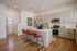 Modern kitchen with sleek cabinetry, stainless steel appliances, and a chic island with leather bar stools.