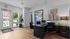 Modern real estate office interior with sleek wooden flooring, elegant office desk, and vibrant elephant artwork, offering a welcoming atmosphere for visitors.