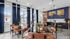 Chic modern dining area with sleek leather chairs and elegant lighting, highlighting stylish decor and expansive windows.