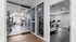 Modern gym space featuring state-of-the-art exercise equipment, bright windows, and sleek mirrored walls.